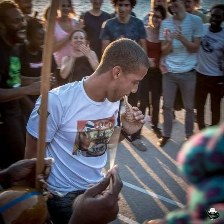 Capoeira Auê roda by the water at sunset